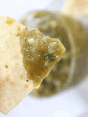 Bowl of homemade Copycat Abuelo’s Fresh Tomatillo Salsa with tortilla chips on the side.