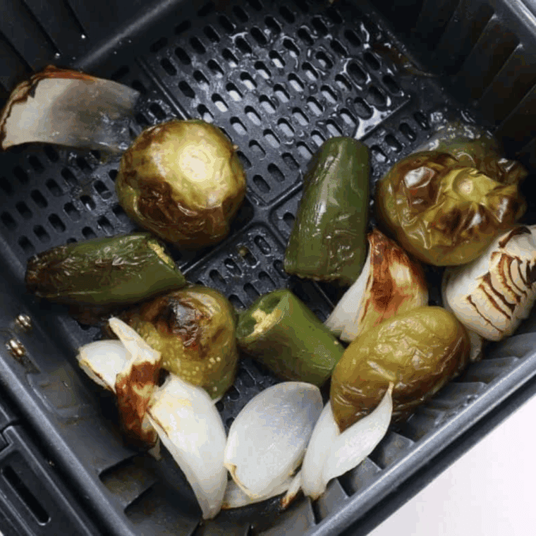 Roasted vegetables in the air fryer basket.