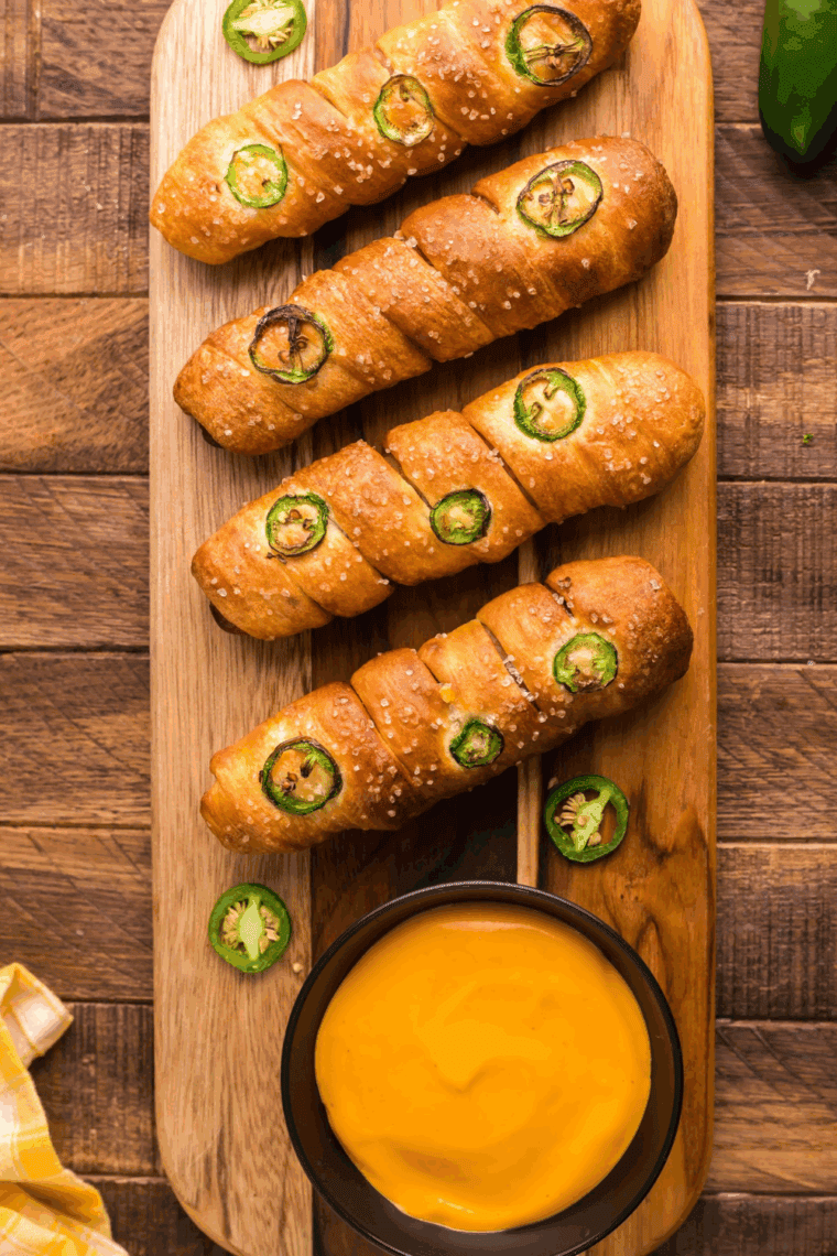 Bowl of warm, cheesy Copycat Auntie Anne’s dip served with soft pretzel nuggets.