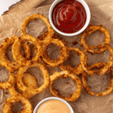 Golden crispy homemade Dairy Queen-style onion rings served with dipping sauce