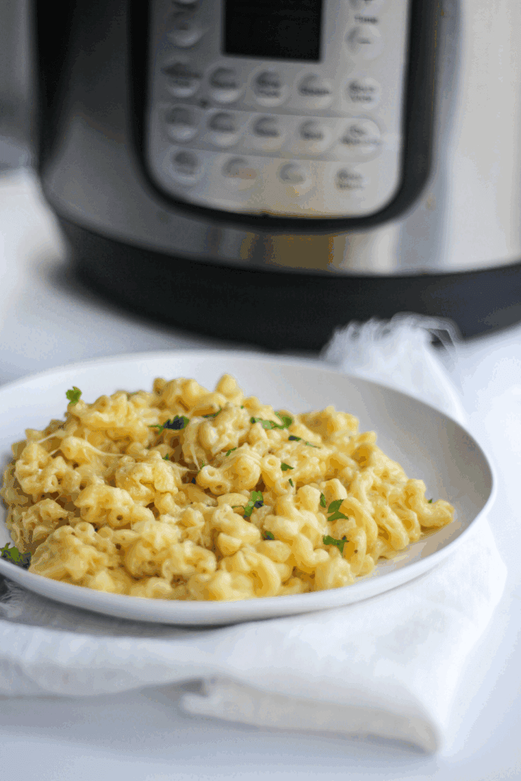Close up of plate of Golden Corral Macaroni and Cheese, next to an instant pot. (pressure cooker)