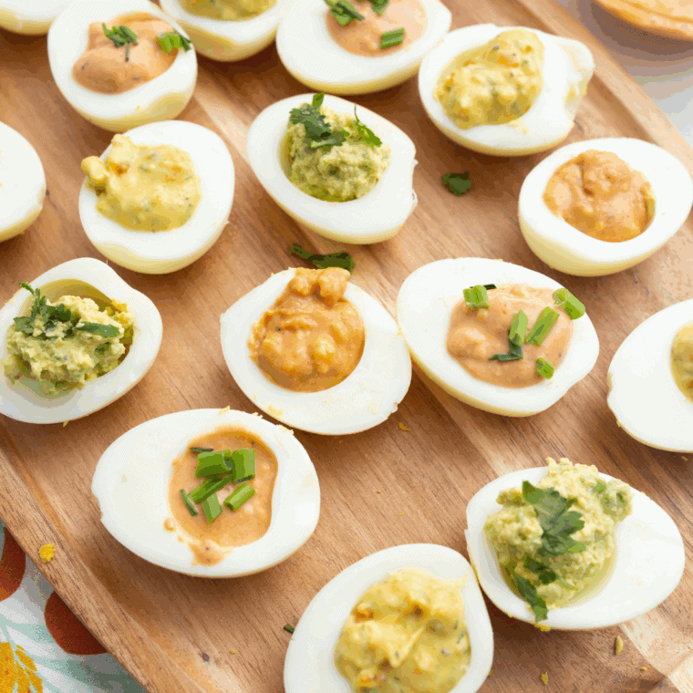 Creamy yolk filling being piped into egg white halves