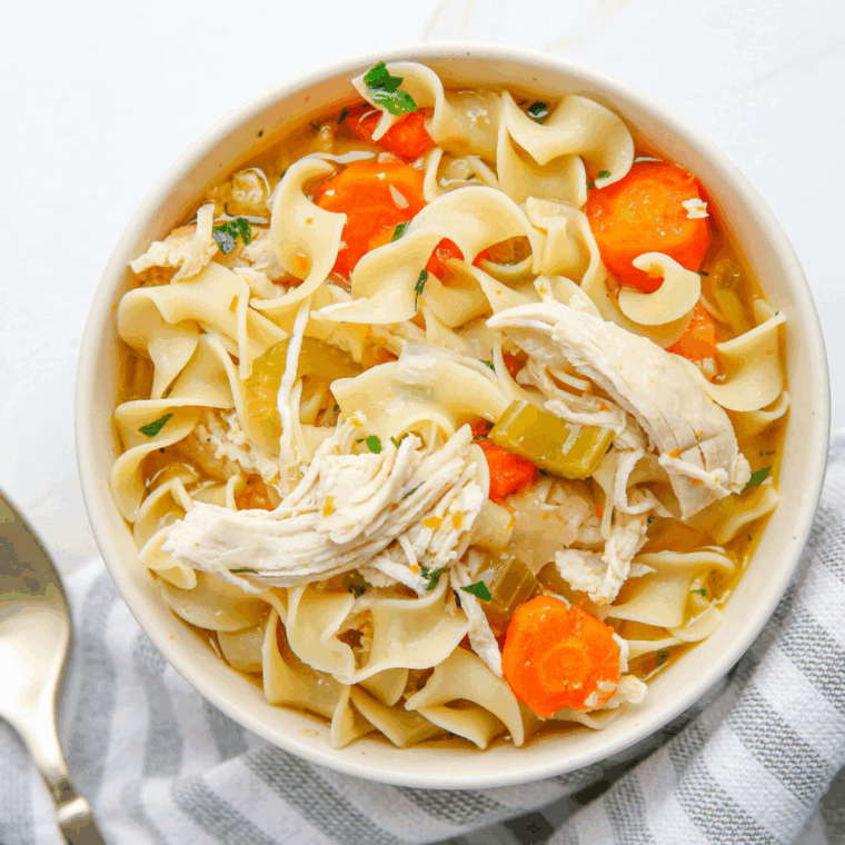 Bowl of Jason’s Deli chicken noodle soup with carrots and noodles