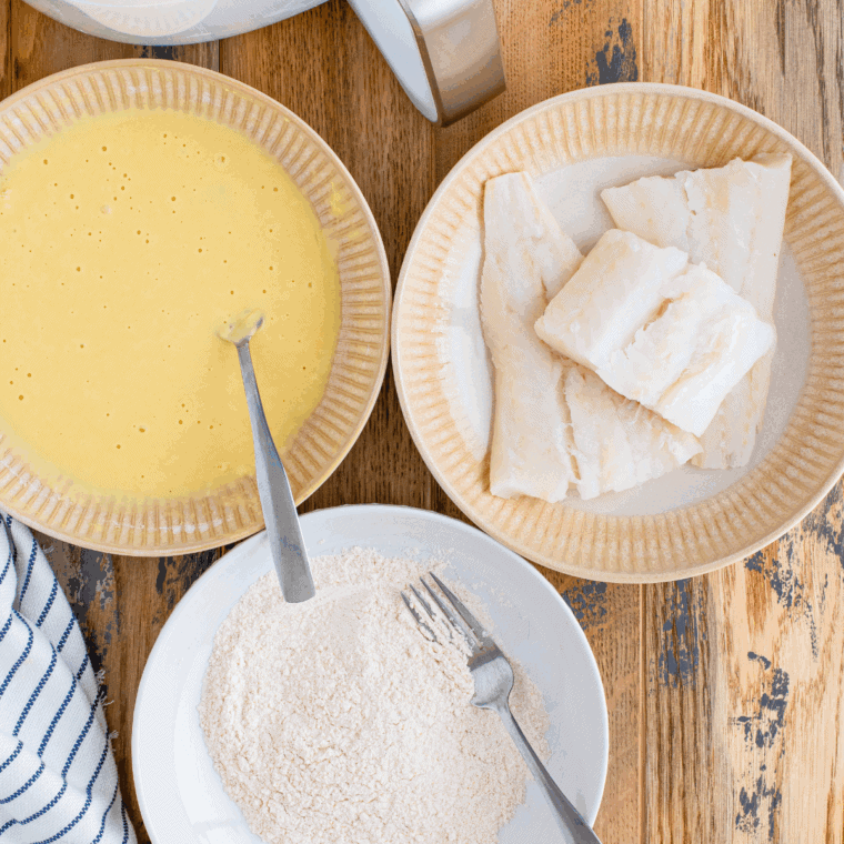 Mixing flour, baking powder, spices, and cold sparkling water to make fish batter.