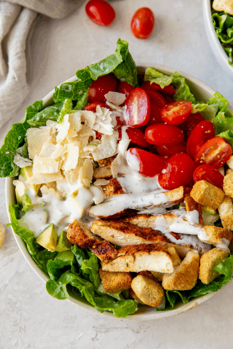 Copycat Longhorn Steakhouse Grilled Caesar Salad with charred romaine lettuce, creamy Caesar dressing, Parmesan cheese, and croutons.