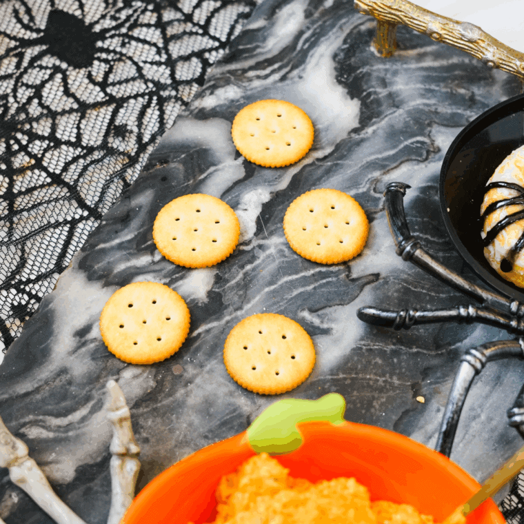 Forming creamy cheese mixture into small round balls.