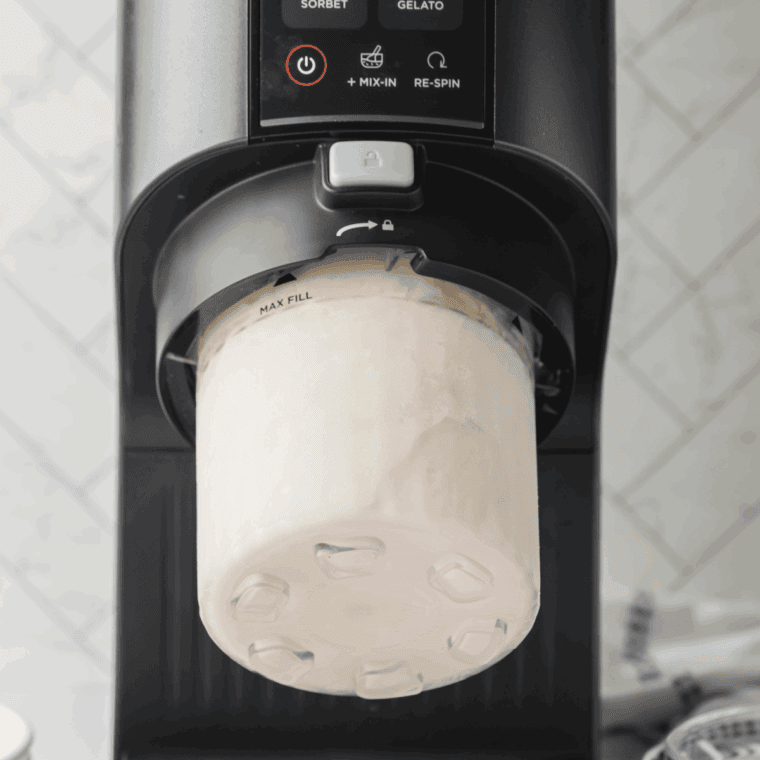 Frozen pint container placed into the Ninja Creami machine ready to process on Ice Cream function