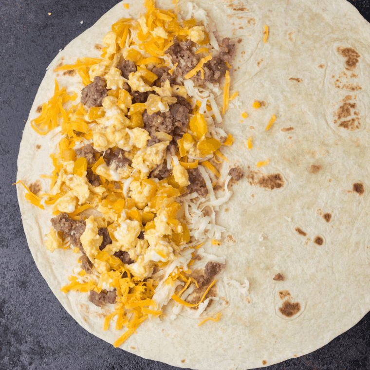 Preheat a skillet or griddle over medium heat and lightly coat with butter or cooking spray. Cook the quesadilla 2–3 minutes per side until the tortilla is golden and the cheese is fully melted.