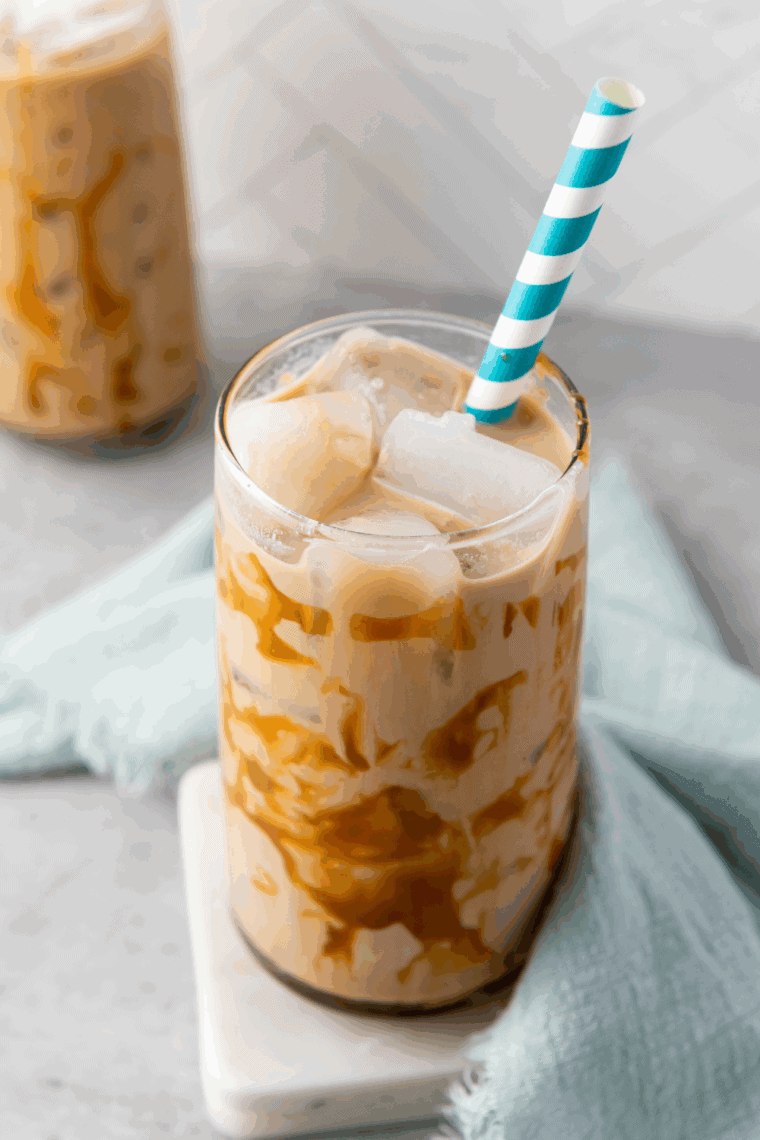 Glass of homemade Tim Hortons-style Iced Capp with frothy top and straw.