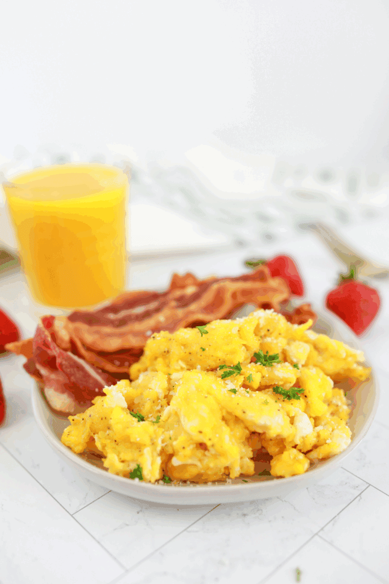 Waffle House style scrambled eggs with toast and breakfast sides being served