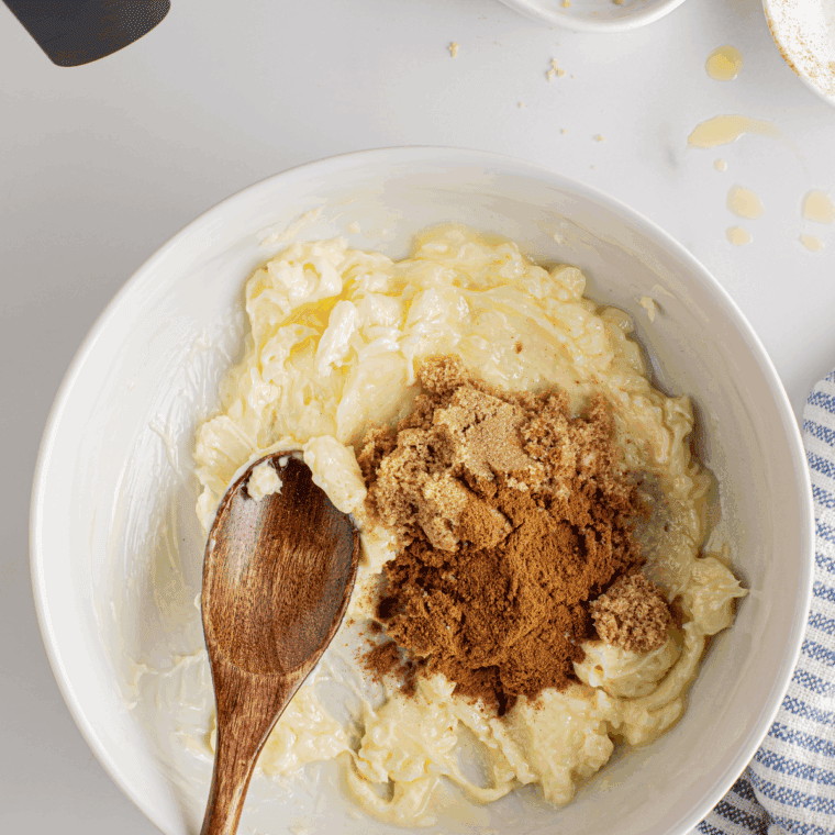 Softened cream cheese mixed with brown sugar, cinnamon, vanilla, and a pinch of salt in a medium bowl.