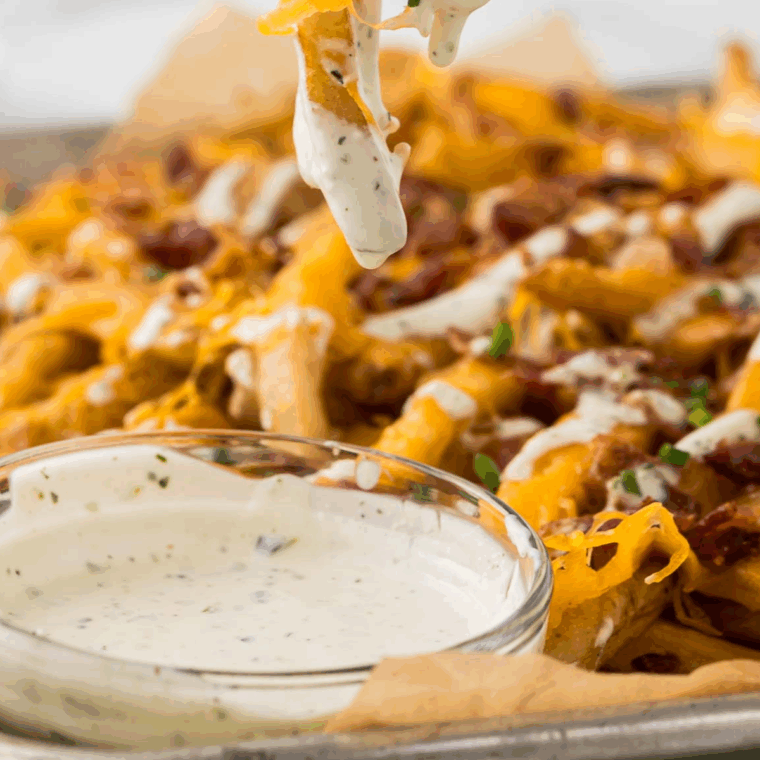 Bowl of creamy Buffalo Wild Wings-style ranch dressing with herbs.