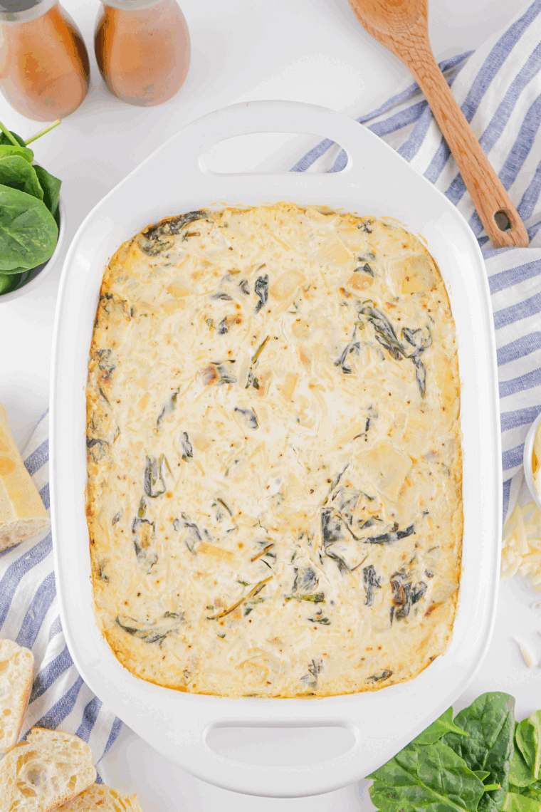 Bowl of creamy Lipton Onion Soup Spinach Dip served with crackers and fresh veggies for dipping.