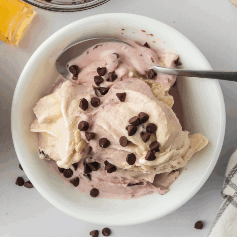 Folding chopped cherries and chocolate chunks into creamy Ninja Creami ice cream using the Mix-In function, ready to serve in bowls or cones."