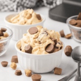 A scoop of Ninja Creami Chocolate Peanut Butter Ice Cream in a bowl topped with peanut butter drizzle and chocolate chips.