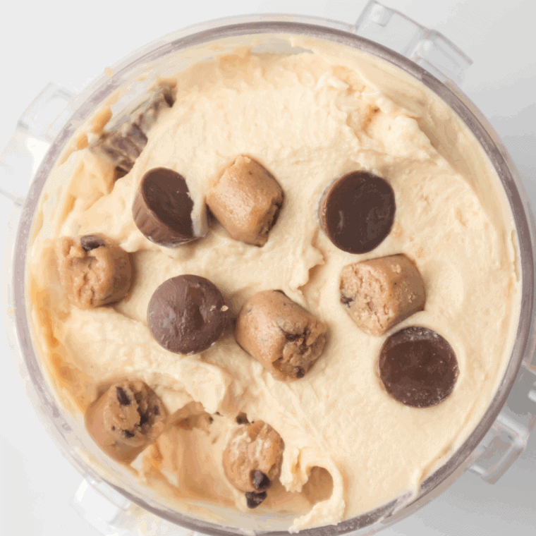 Bowl of creamy Ninja Creami Chocolate Peanut Butter Ice Cream topped with chocolate chunks and peanut butter drizzle.
