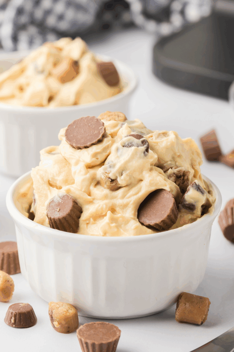Creamy Ninja Creami Chocolate Peanut Butter Ice Cream topped with peanut butter drizzle and chocolate chunks in a bowl.