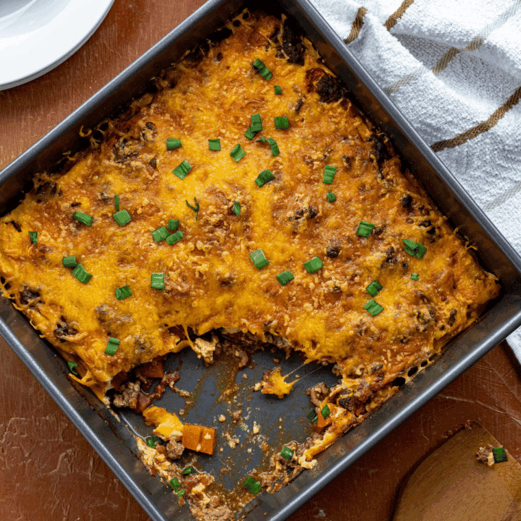 Slice of Pioneer Woman’s Cheeseburger Pie with melted cheddar cheese and golden crust on a plate.