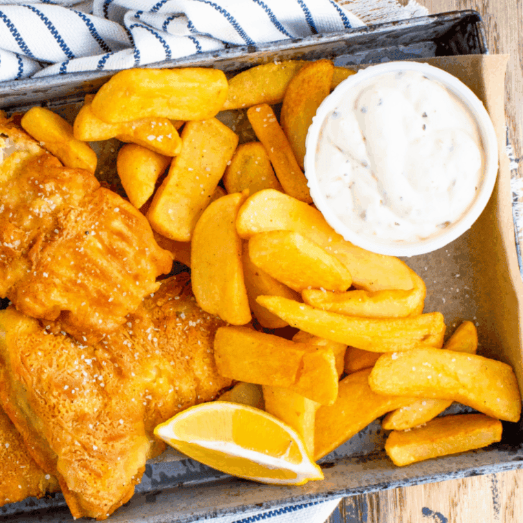 Creamy tartar sauce served in a bowl alongside fried fish, seafood, or sandwiches.