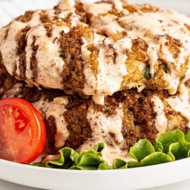 Golden-brown crab cakes made with fresh lump crab meat, served with lemon wedges.