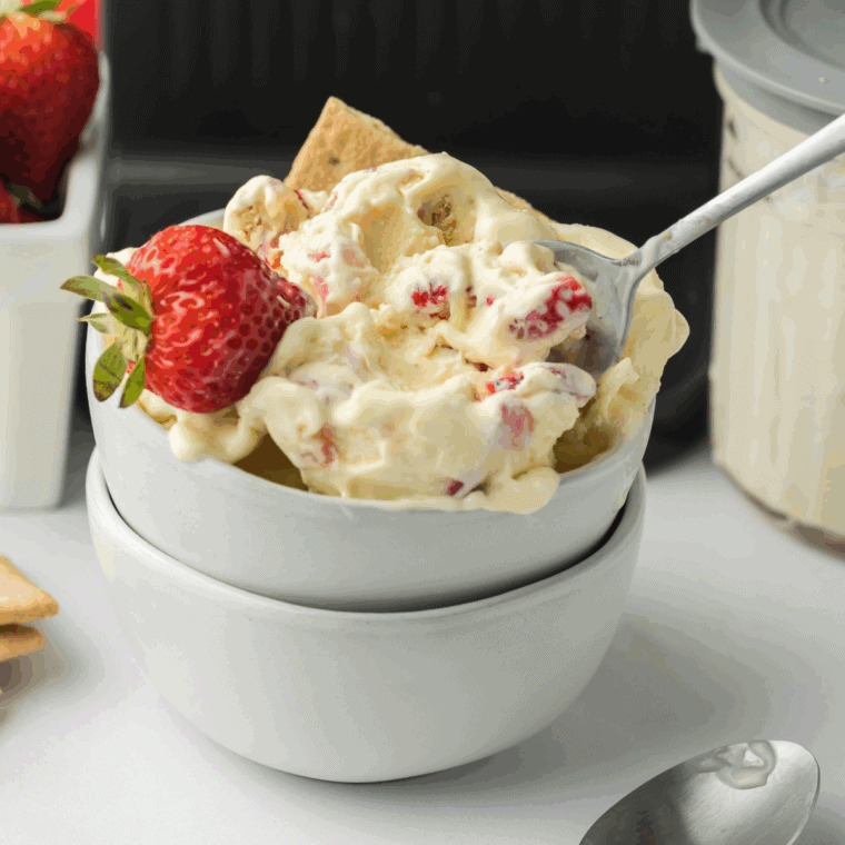 Scooping homemade Baseball Nut Ice Cream with raspberry swirls and cashews into cones and bowls.
