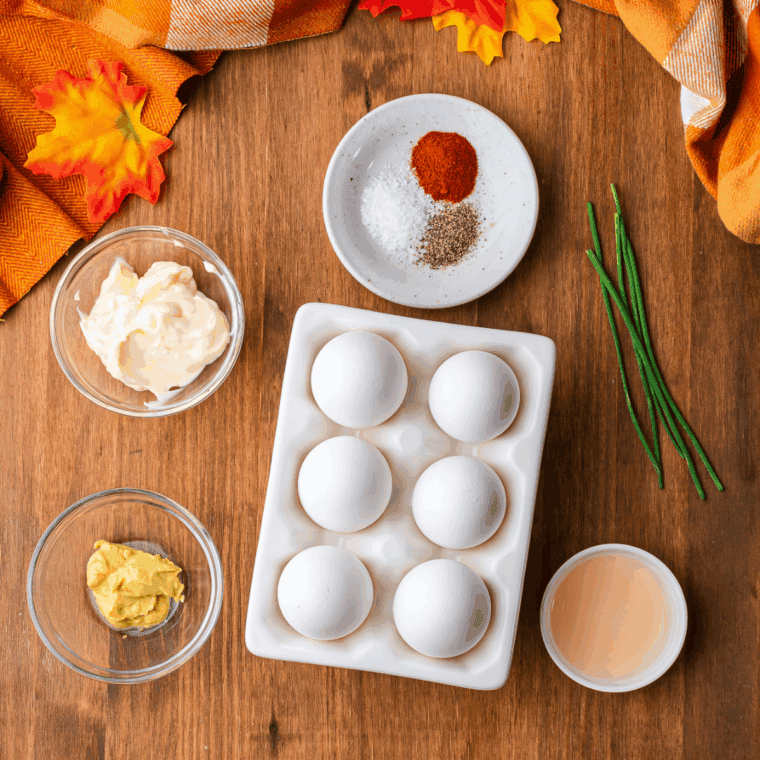 Ingredients for pumpkin deviled eggs: eggs, mayonnaise, mustard, paprika, and chives