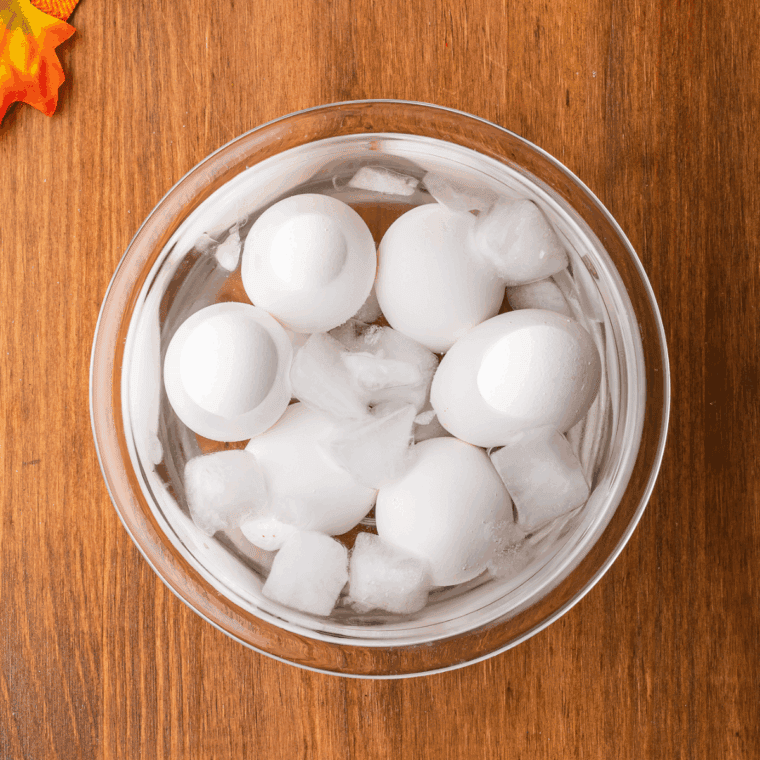 Hard-boiled eggs cooling in a bowl of ice water