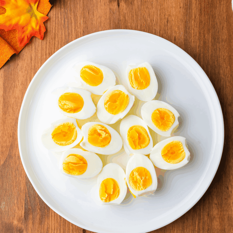 Peeled hard-boiled eggs sliced in half with the yolks removed
