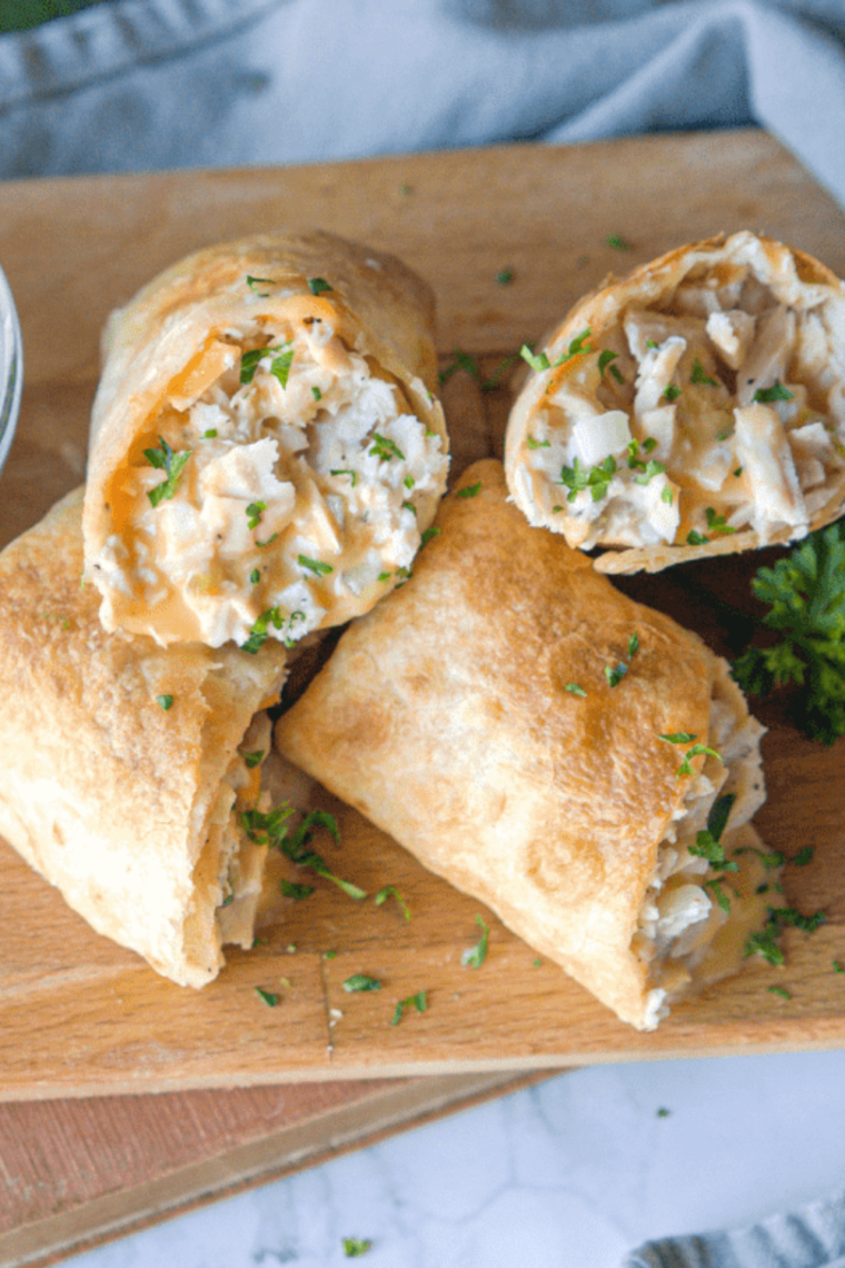 American cheese laid point-to-point on a split sub roll before adding tuna salad.