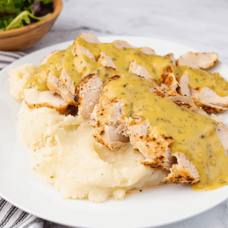 Small bowl of honey mustard marinade with a whisk, ready for chicken