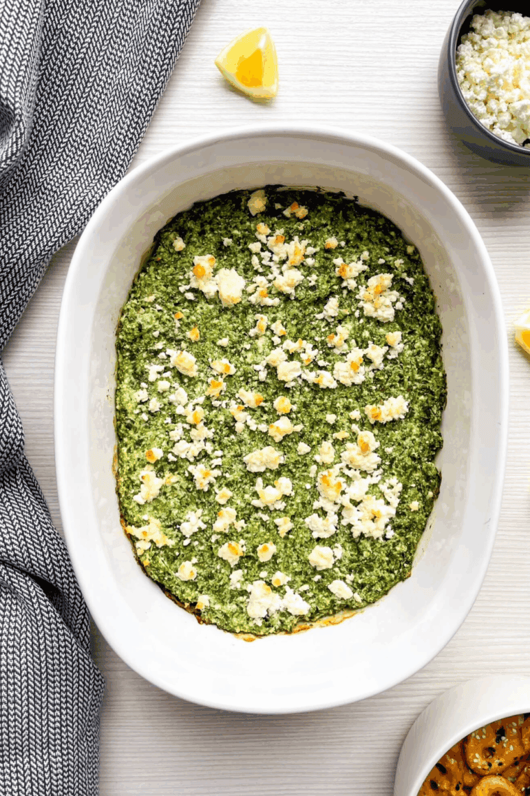 Cooling baked spinach dip slightly and serving with crackers or bread.