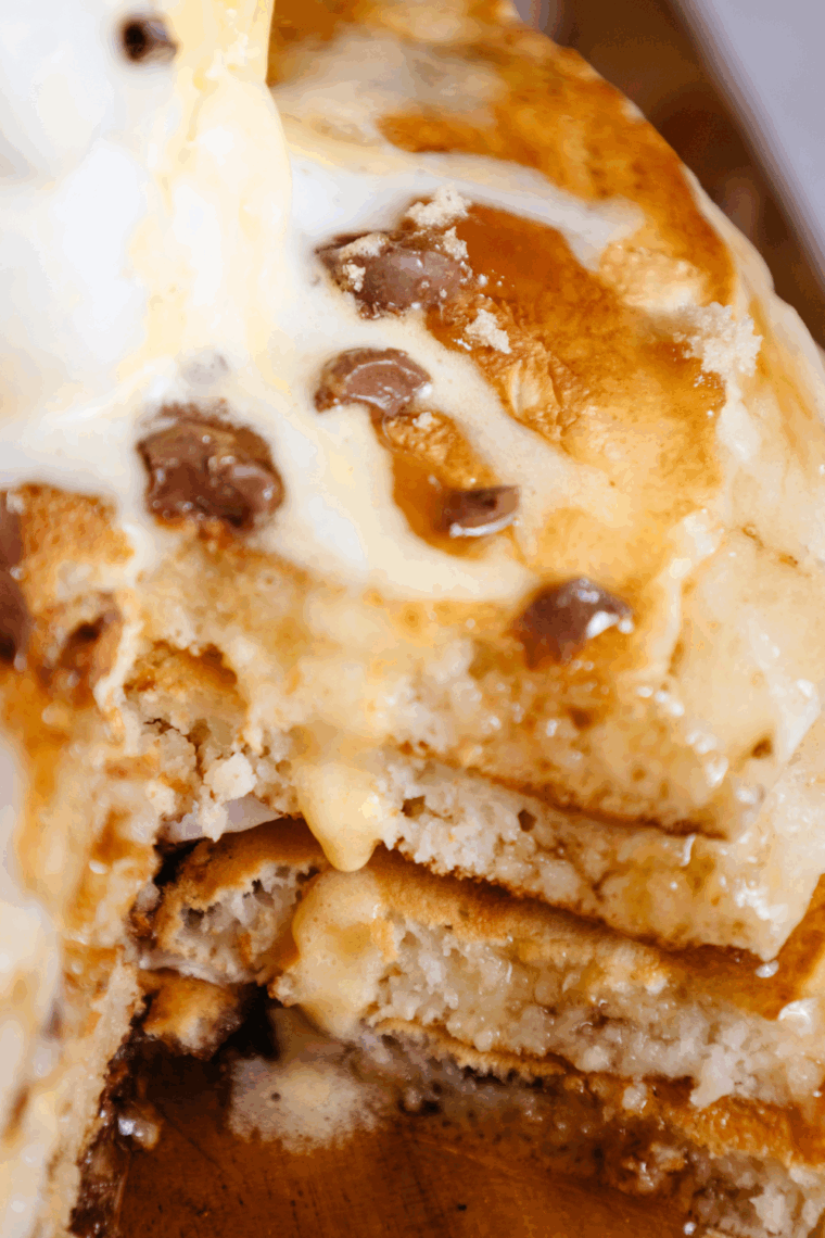Stack of homemade Denny’s-style pancakes topped with syrup and butter.