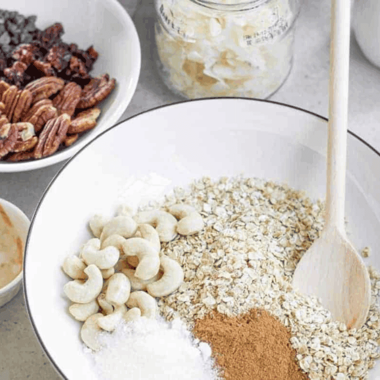 Mixing rolled oats, almonds, sunflower seeds, wheat germ, brown sugar, cinnamon, and salt in a large bowl.