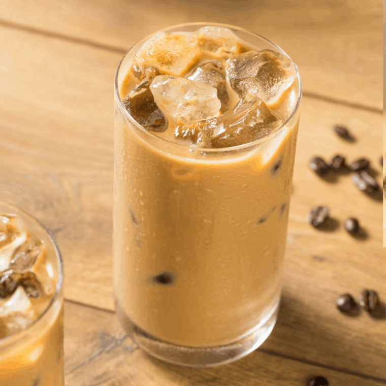Glass of First Watch-style iced coffee with ice cubes and a splash of milk.