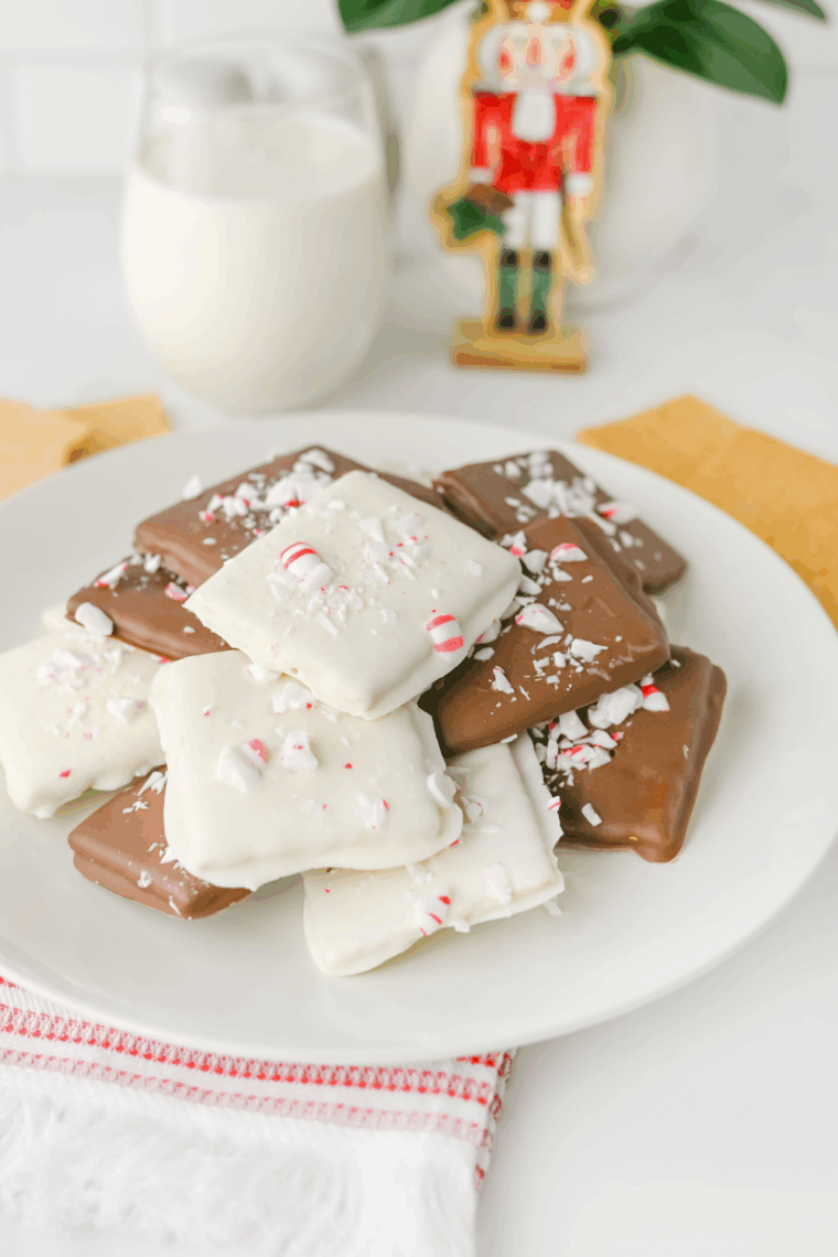 Stacked Easy Peppermint Crunch Graham Crackers dipped in white chocolate and generously covered with crushed red and white candy canes.