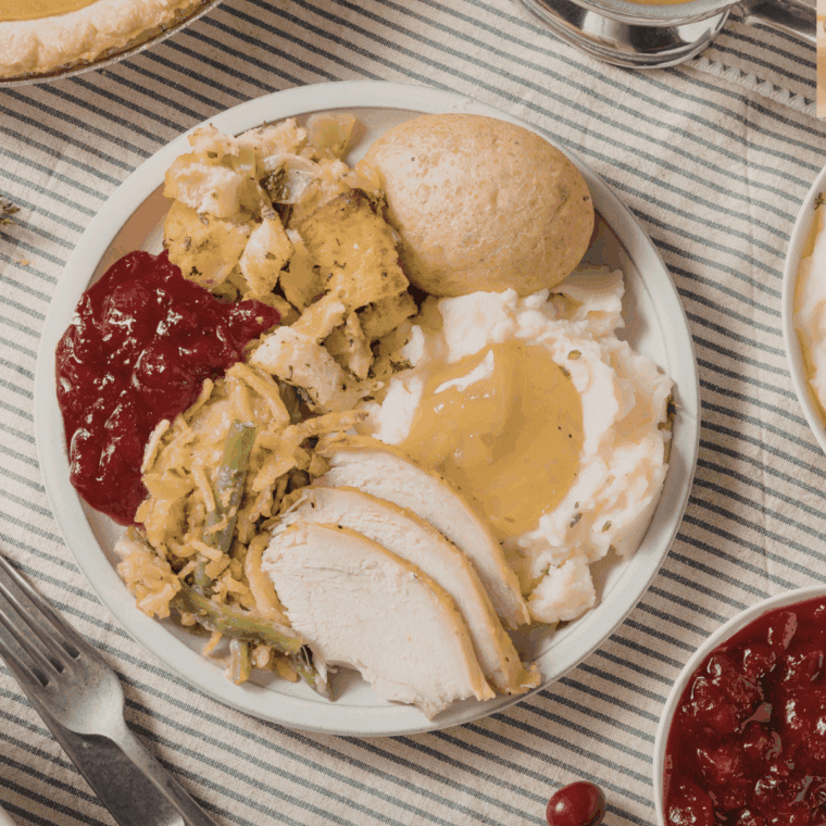 homemade turkey gravy made from roasted turkey drippings in a saucepan with a spoon