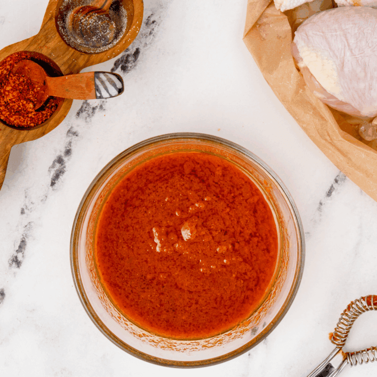 Chiles, garlic, vinegar, water, and salt in a blender being pureed into smooth Valentina hot sauce, with adjustments for consistency and flavor.