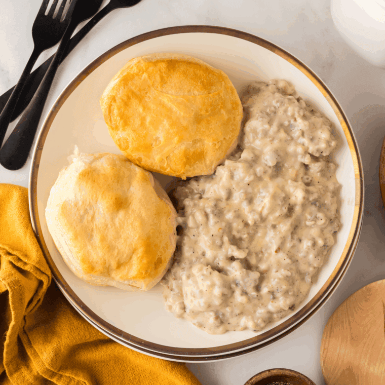 Keto Sausage Gravy on plate with keto biscuits.