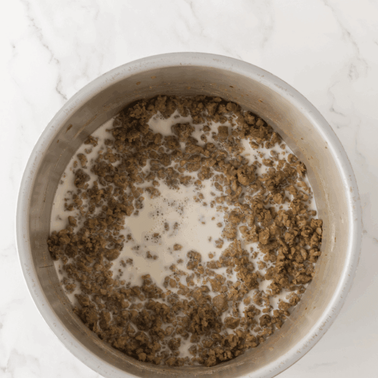 Brown the sausage in a small skillet, and then add cream cheese and melt.