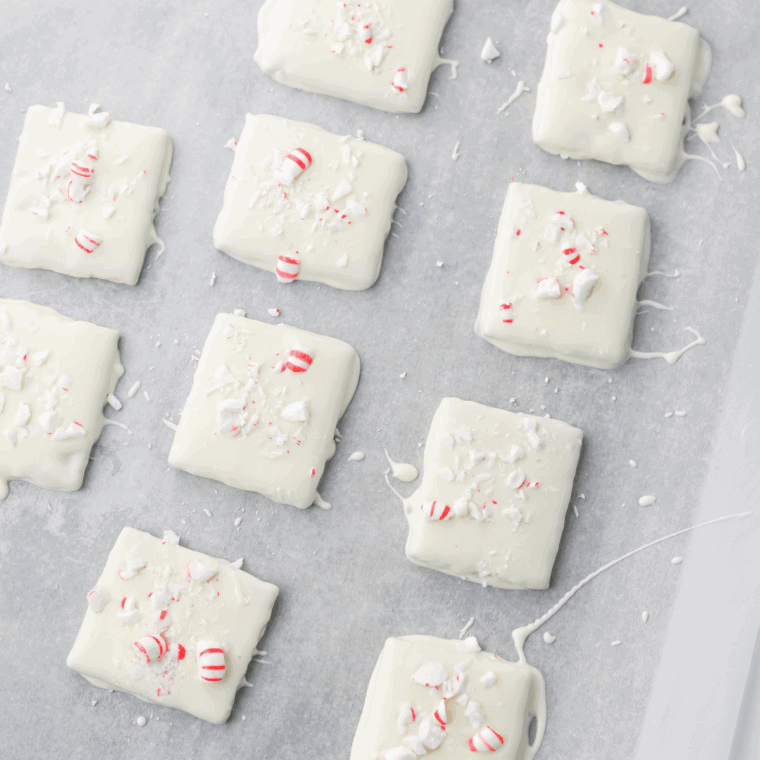 Peppermint sprinkled on coated graham crackers while setting