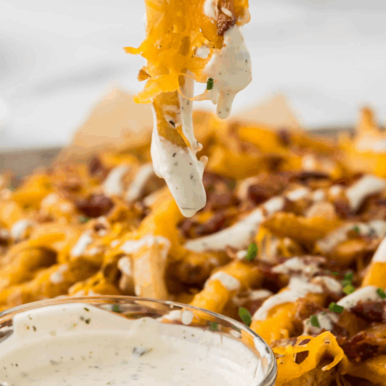 Creamy Ruth’s Chris style ranch dressing served in a small bowl with fresh herbs