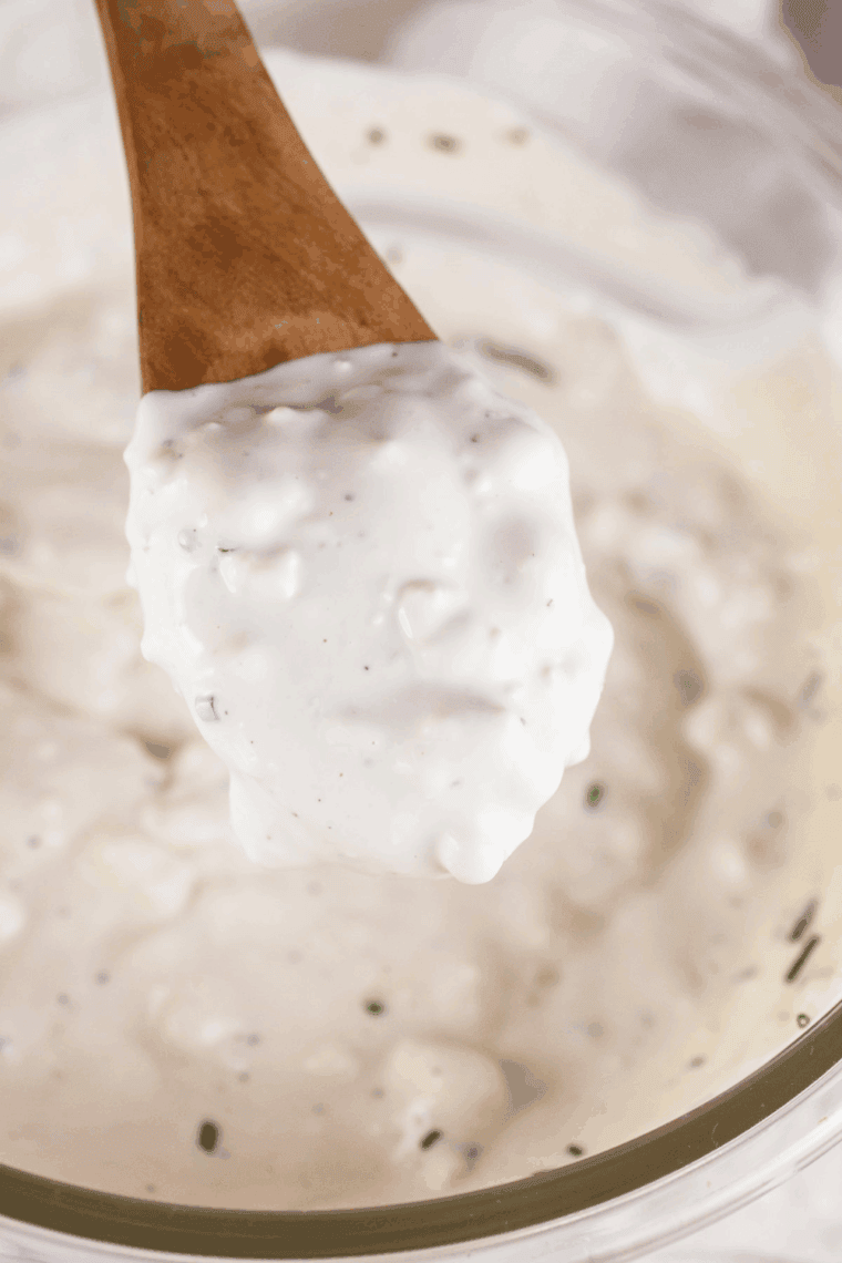 Thick and creamy homemade Ruth's Chris style Blue Cheese Dressing in a white bowl, showing large, visible crumbles of blue cheese.