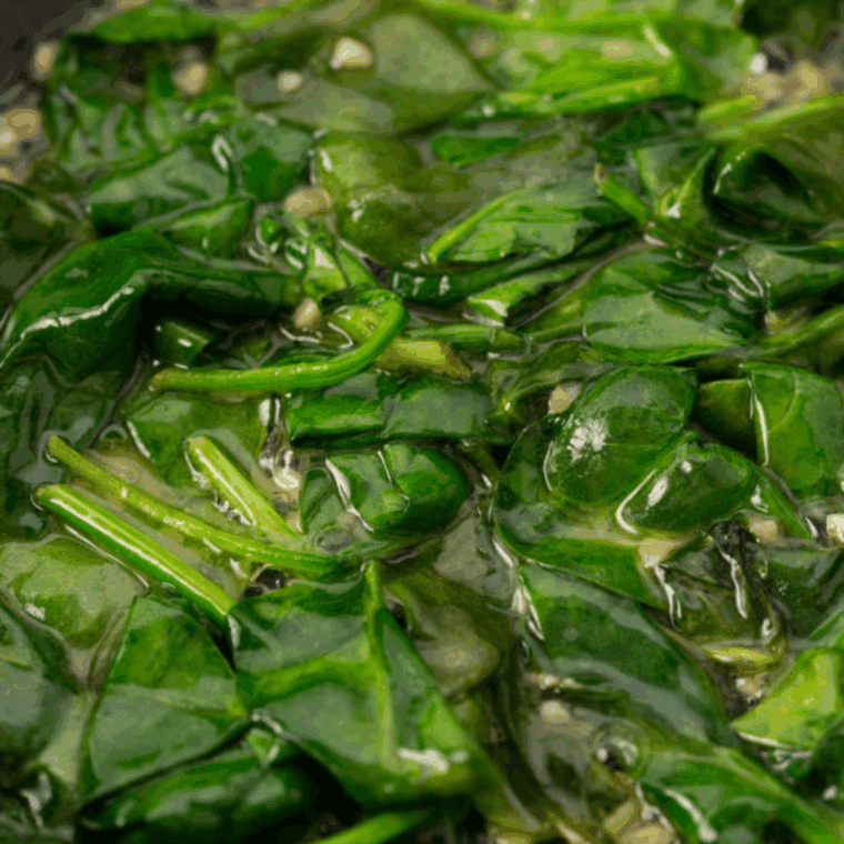 Velvety, creamy Ruth’s Chris-style creamed spinach served in a white dish.