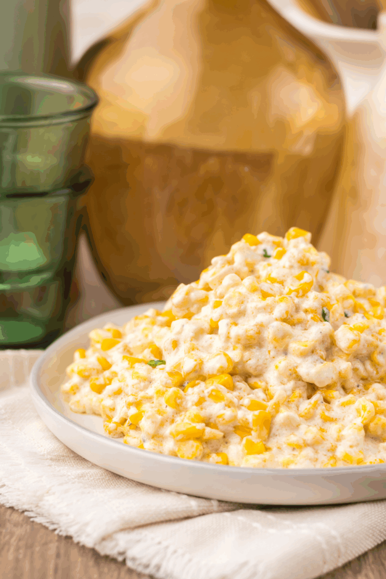 Slow Cooker Ruth’s Chris Creamed Corn served in a bowl — creamy, buttery corn topped with a sprinkle of parsley and black pepper.