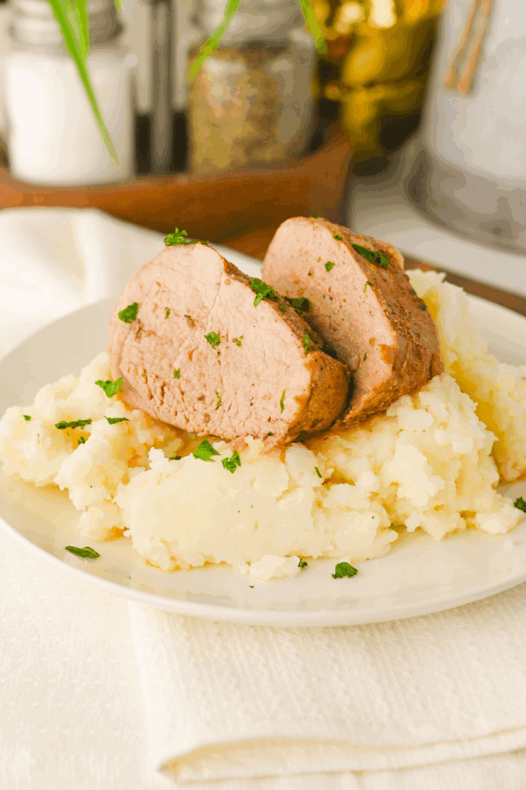 Garlic herb gravy thickening in the slow cooker after stirring in a cornstarch slurry