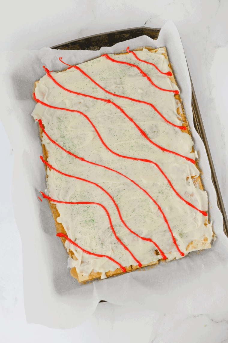Little Debbie Christmas Tree Cake Crack with chocolate drizzle and colorful sprinkles