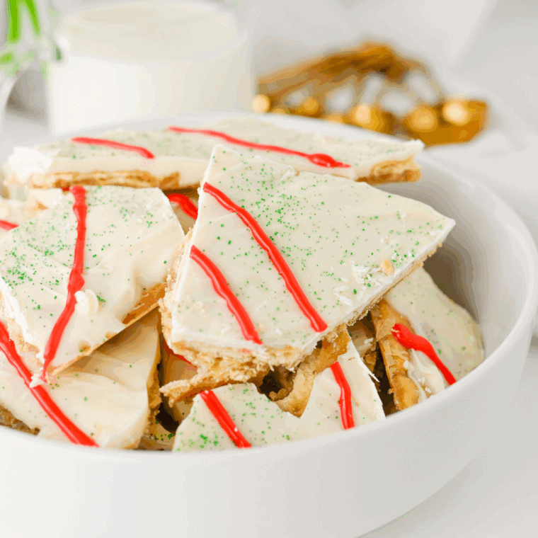 Little Debbie Christmas Tree Cake Crack with chocolate drizzle, green sanding sugar, and red icing