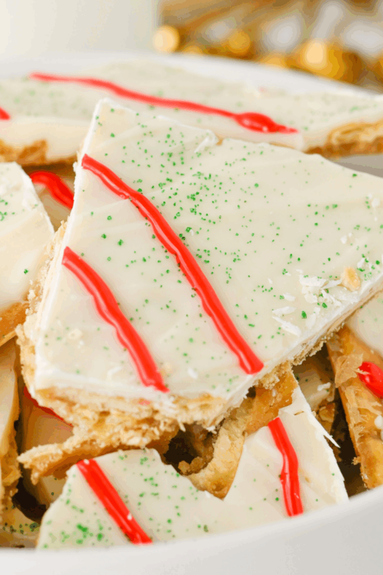 Red icing piped on toffee to resemble Christmas Tree Cakes
