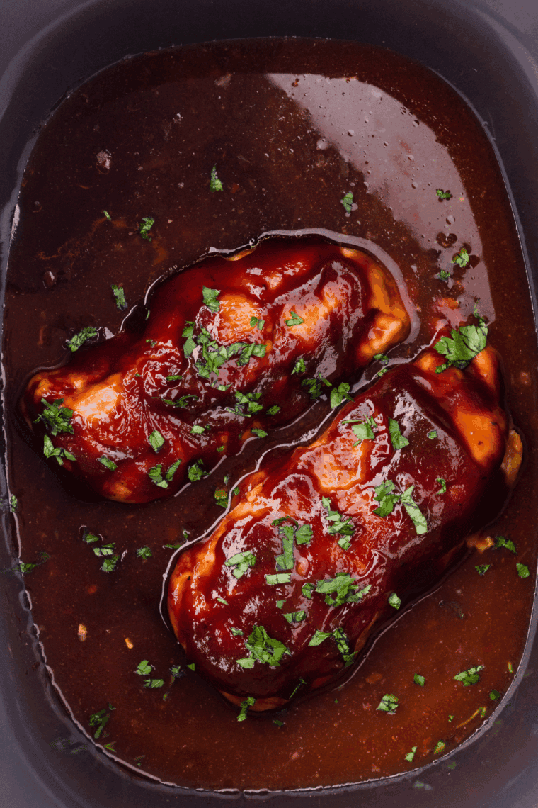 Slow cooker covered and cooking chicken on low or high until tender.