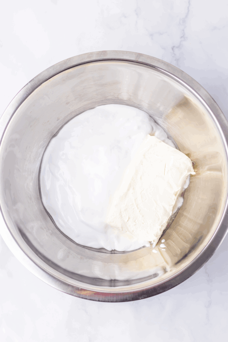 Mixing cream cheese, marshmallow fluff, and peppermint extract until smooth